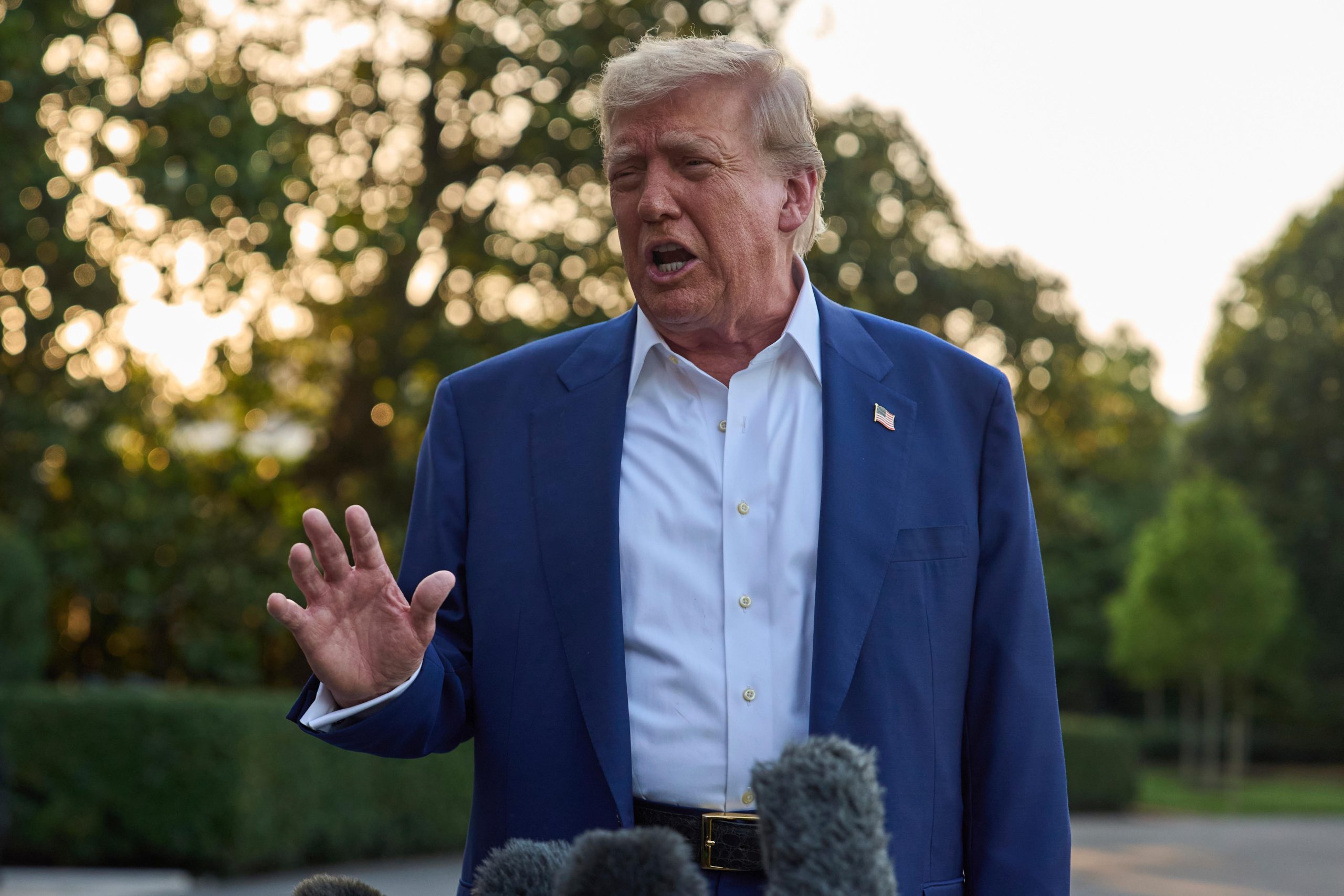 President Donald Trump speaks with reporters before boarding Marine One...