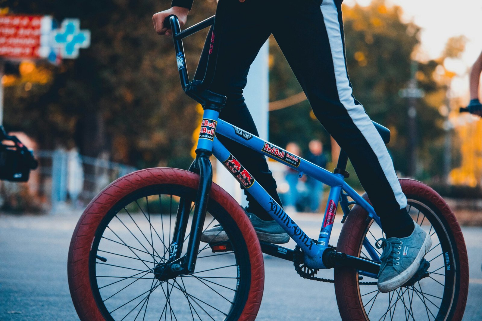 A cyclist riding in a scenic park with a fitness tracker on their wrist.
