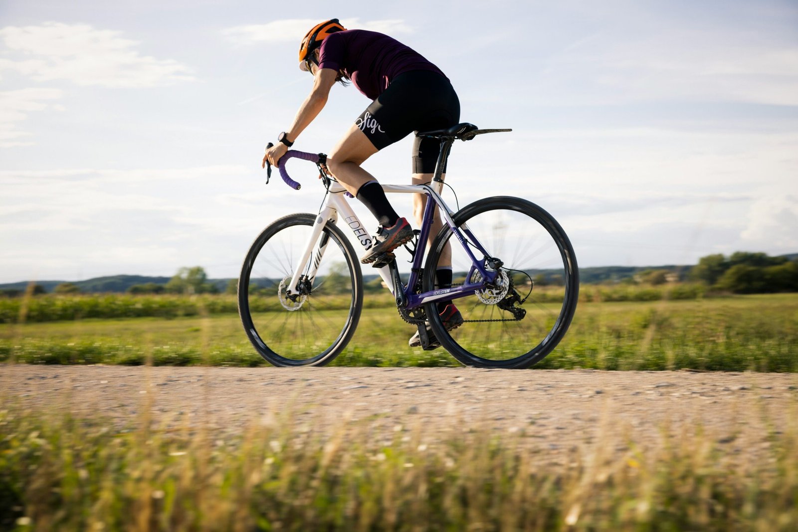 Man looking frustrated next to his bicycle after a failed attempt at cycling fat burn
