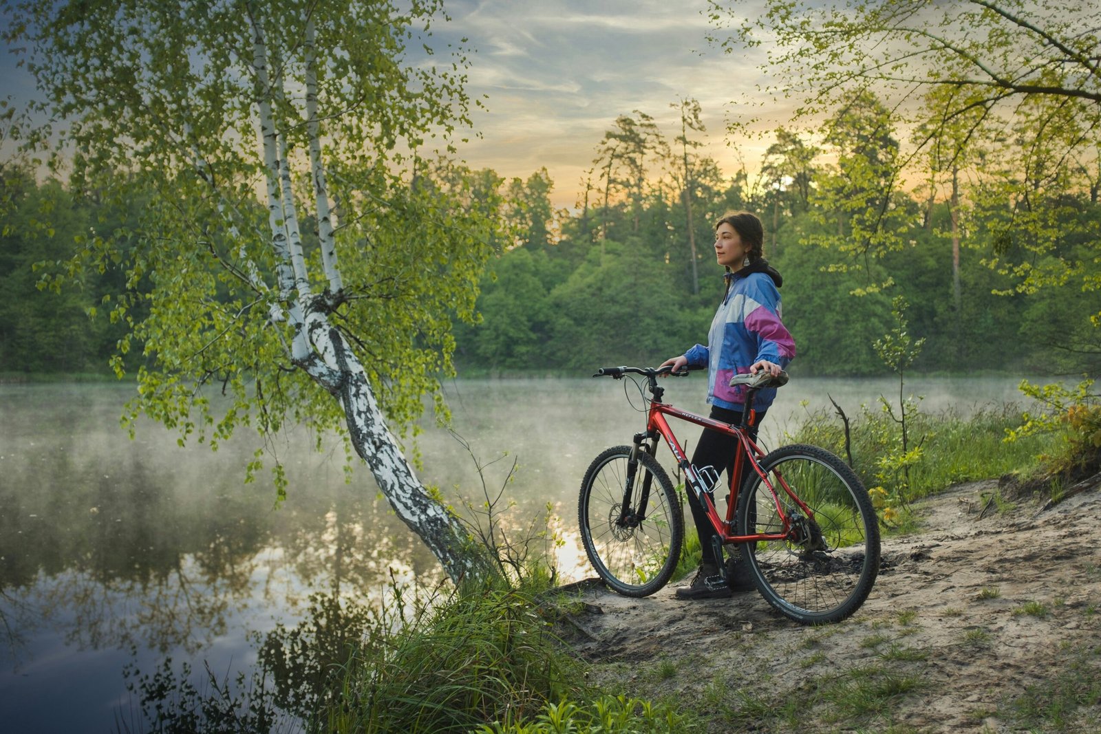 Woman cycling outdoors with scenic mountain background