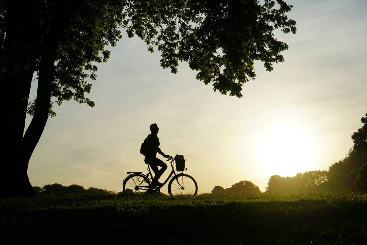 A cyclist smiling next to their bike after significant weight loss