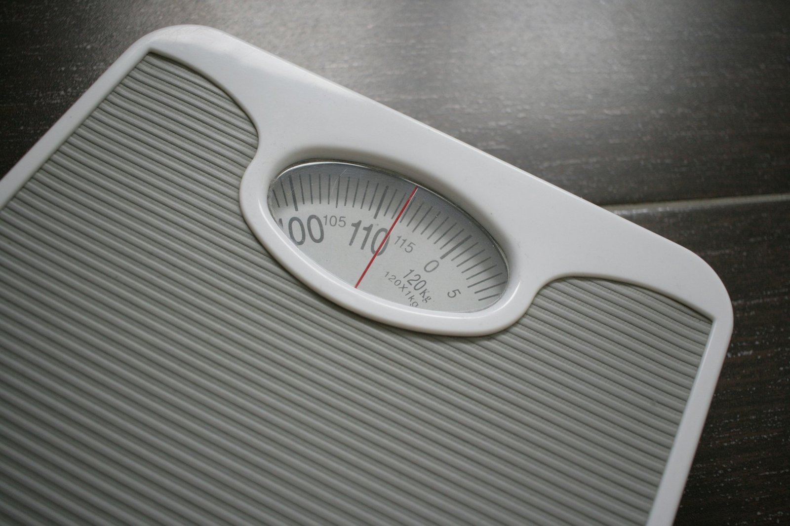 A person struggling to lose weight on a scale