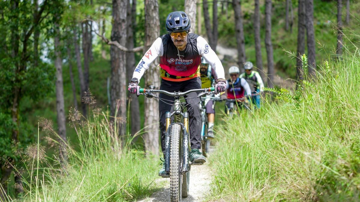 A cyclist riding through scenic hills