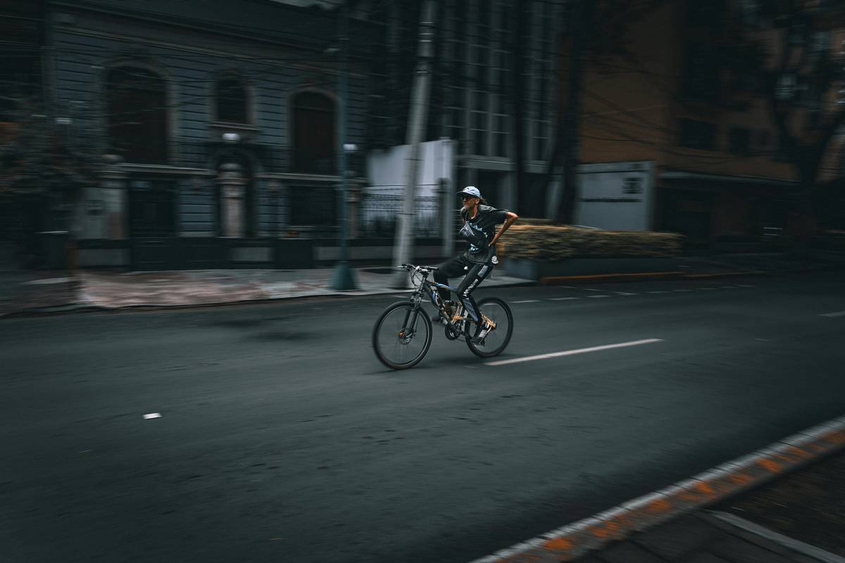 A cyclist riding uphill during sunrise