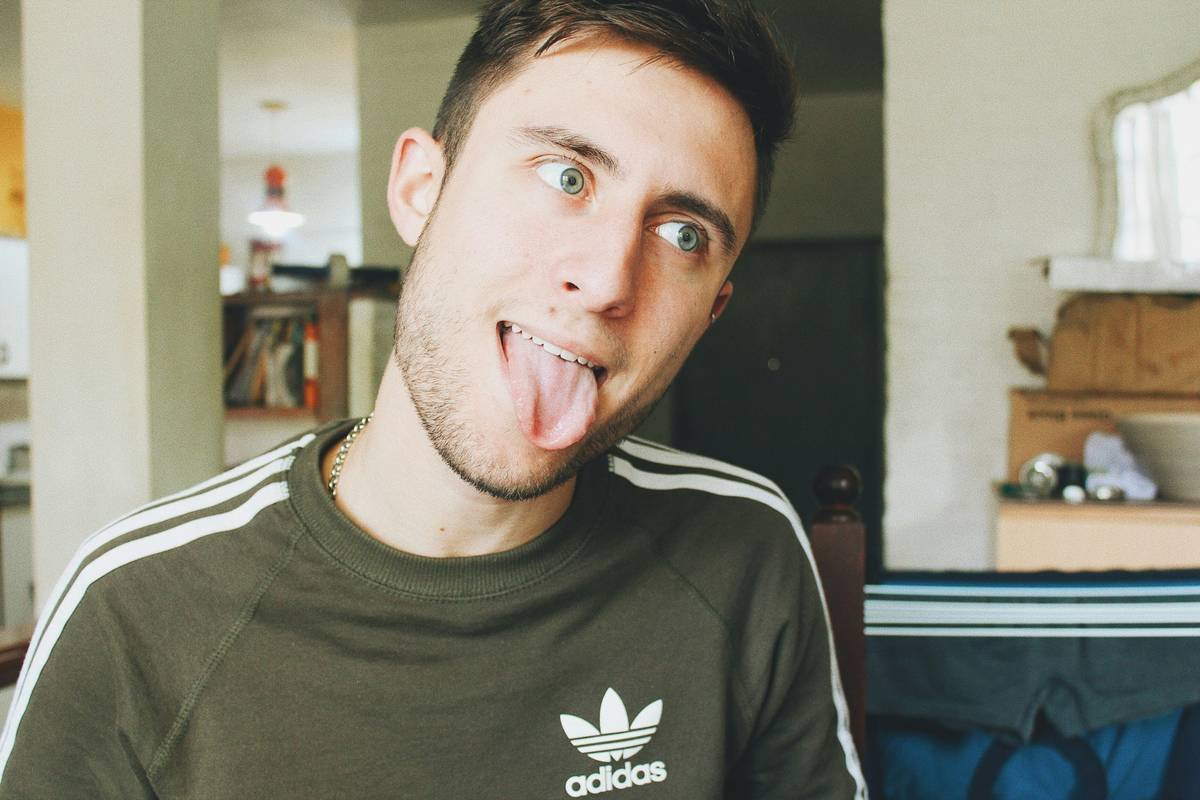 A group of smiling cyclists gathered after a morning ride in the park.