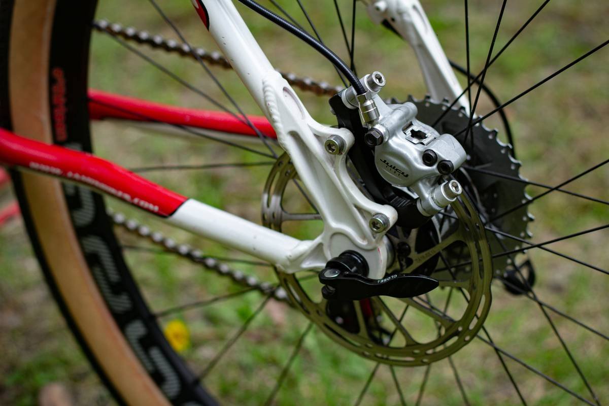 Closeup of hand turning spin bike resistance dial