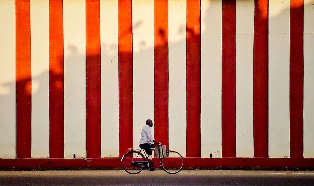 Woman smiling next to a bicycle after losing weight
