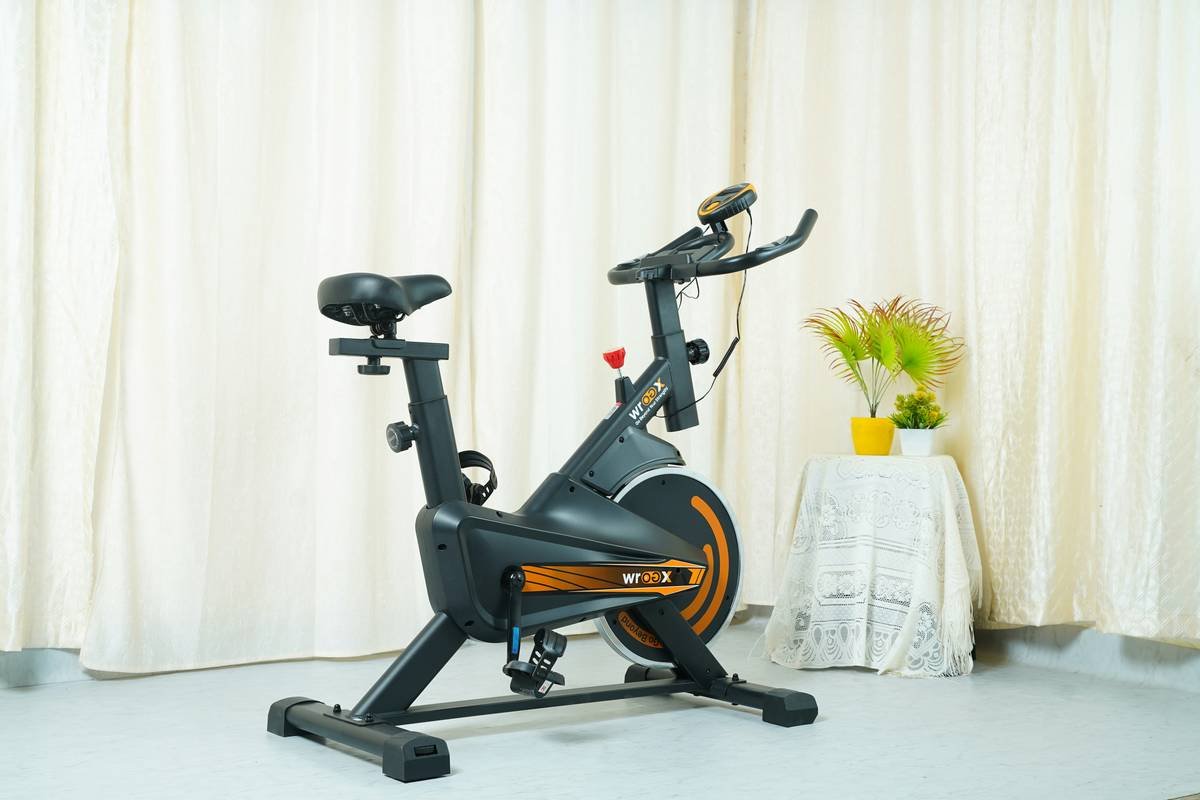 A cyclist mid-spin workout on a stationary bike indoors