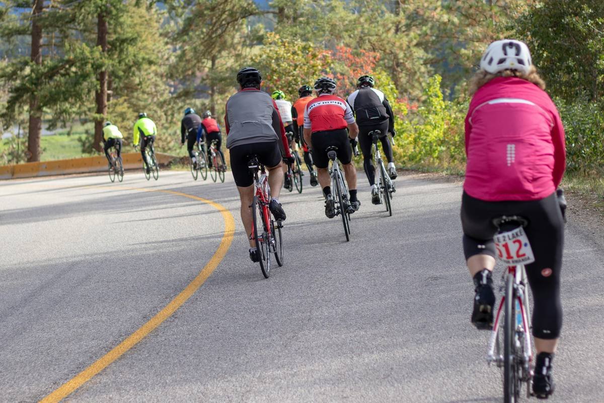A cyclist riding uphill on a scenic trail during sunrise