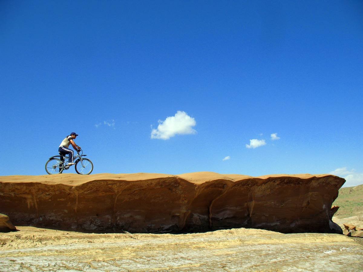 Happy cyclist celebrating weight loss victory near her bicycle