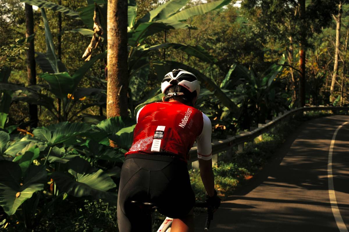 A cyclist using a fitness tracker while riding outdoors.