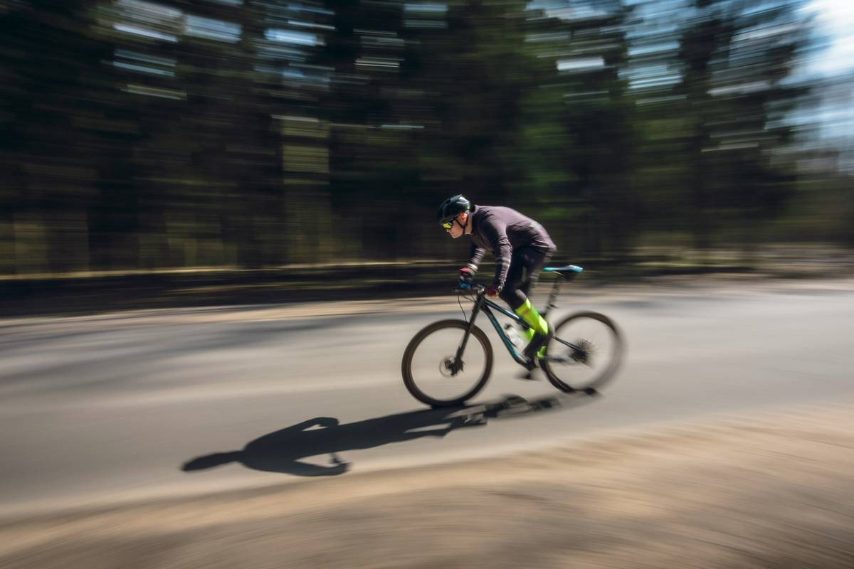 a man riding a bike down a street
