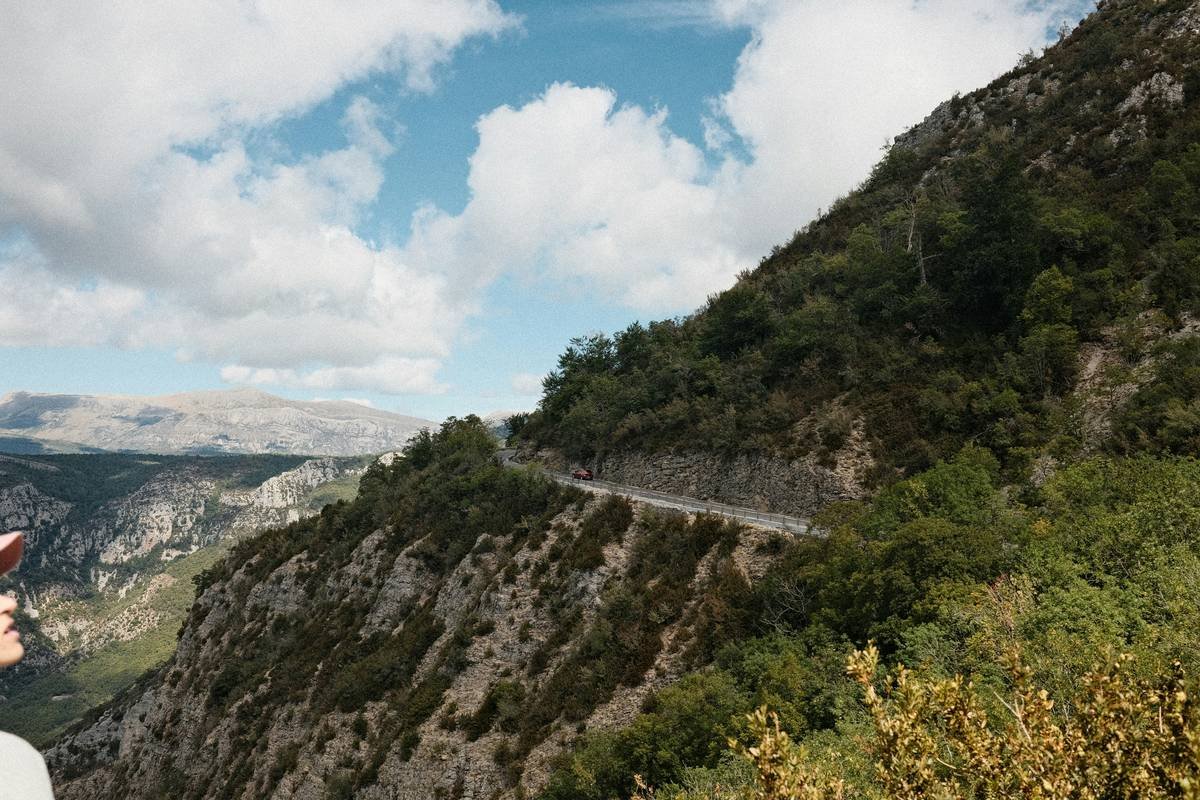 A winding road carved into a steep, rocky mountainside.
