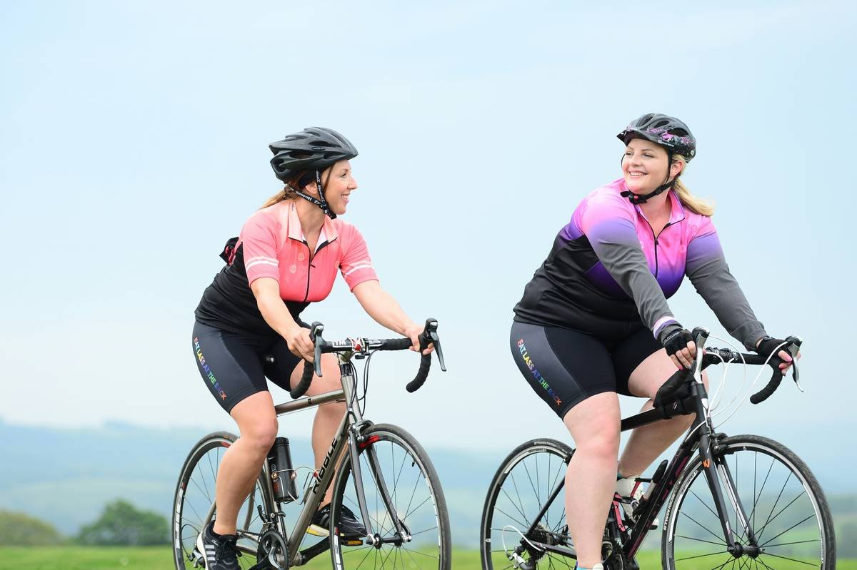 Two female cyclists riding their bikes through the Yorkshire countryside on a sunny day. Photographer Simon Wilkinson swpix.com