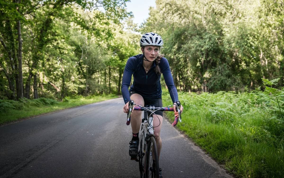 woman celebrating mid-cycling weight loss challenge with visible results